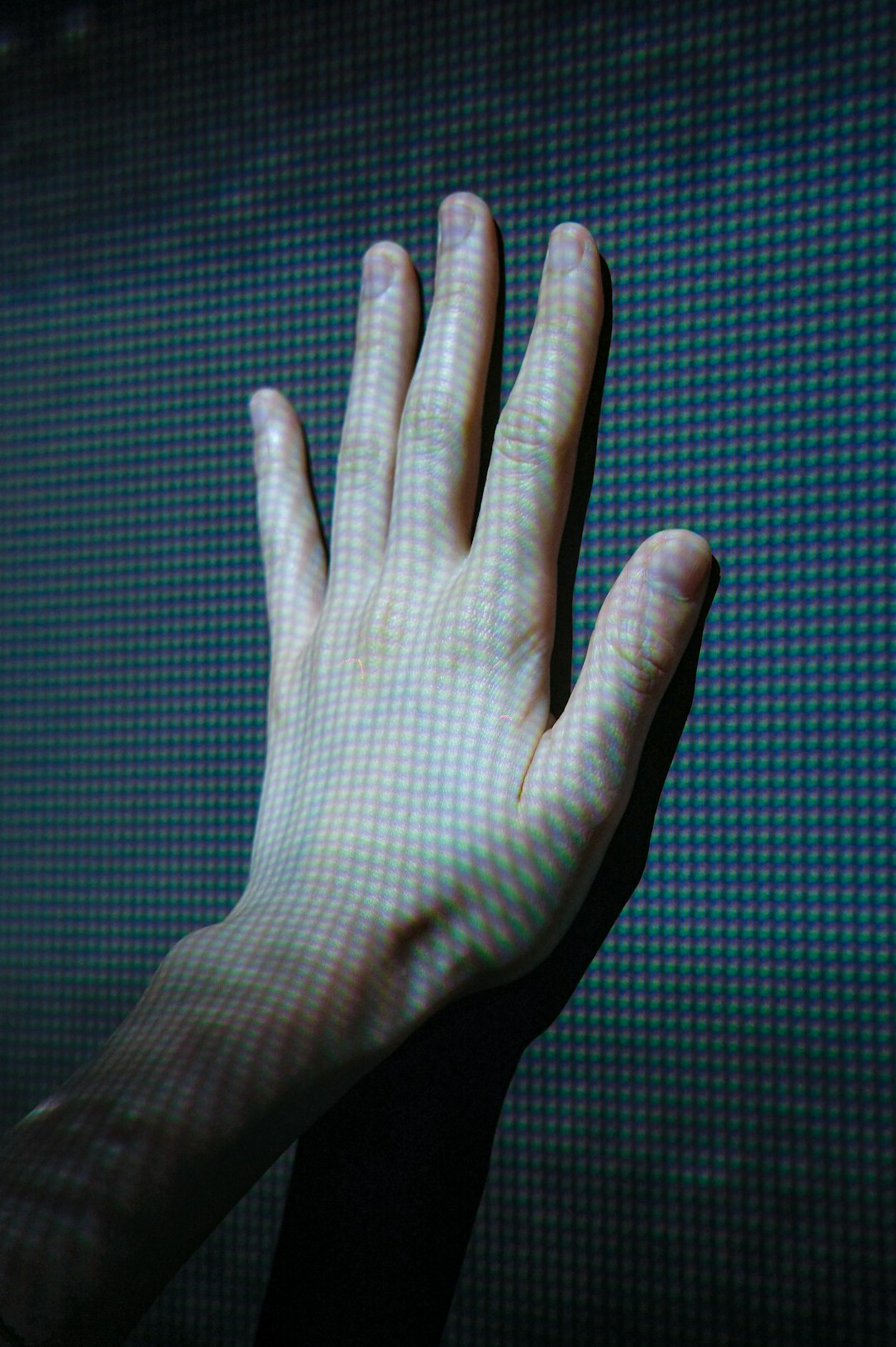 Hand interacting with a holographic digital interface