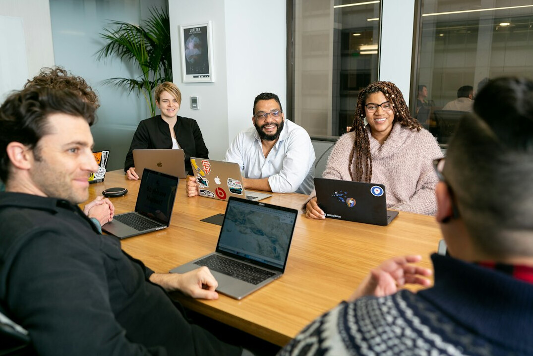 team discussing insurance software